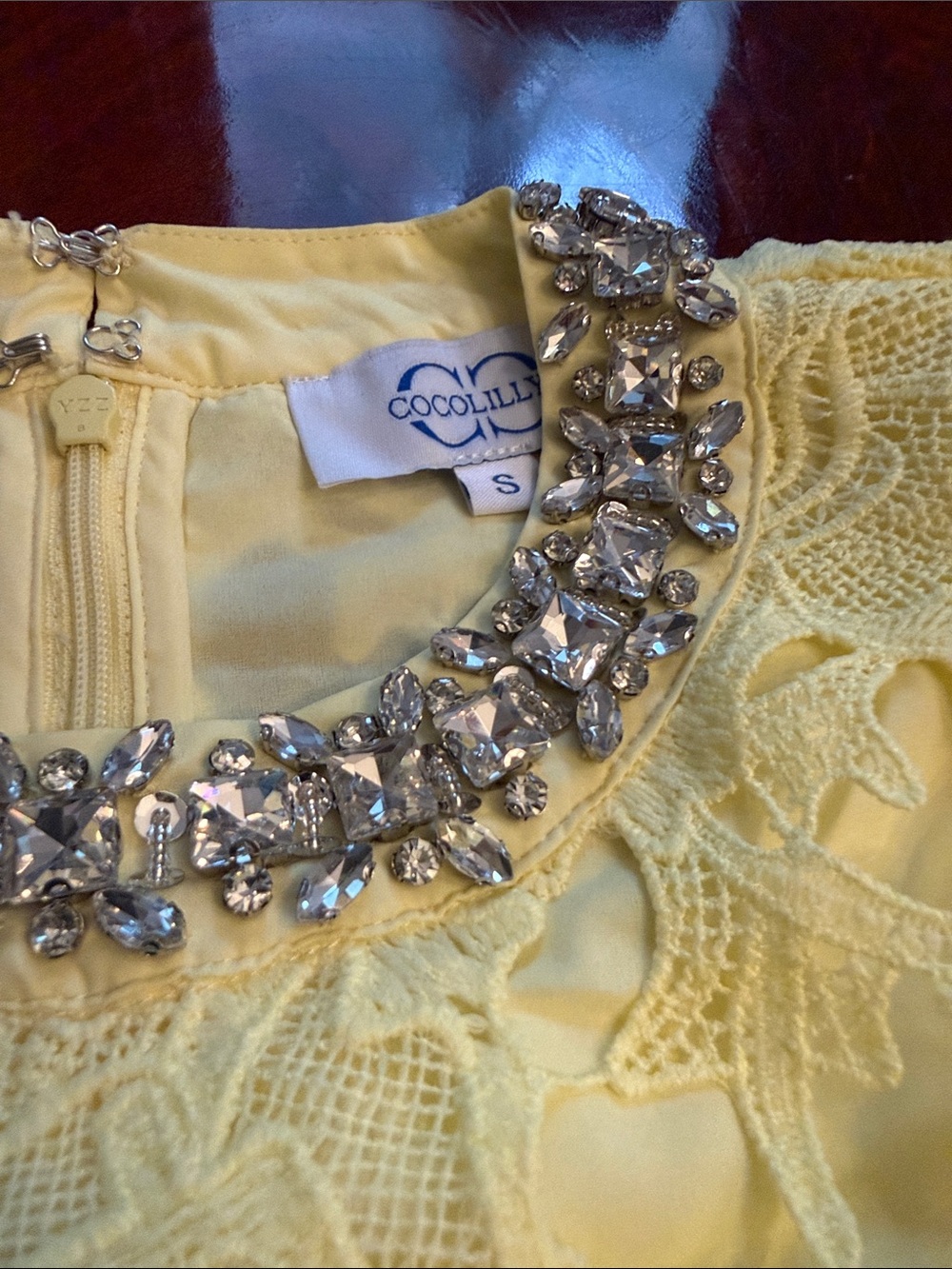 Women’s Mini Dress with Yellow Crochet Lace Detail and diamond neckline.
